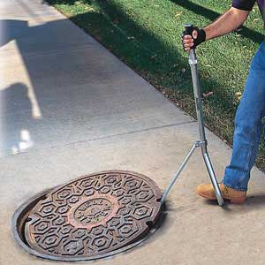 Deluxe Manhole Lid Lifter in use