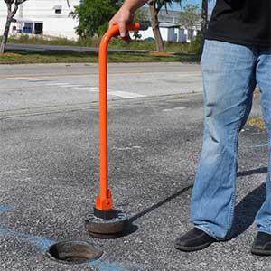Break 'N Take 1 Magnetic Manhole Cover Lifter in use